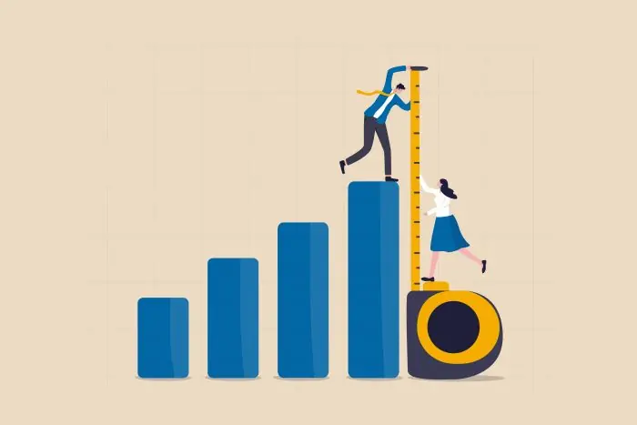 Illustration of two people measuring a rising blue bar chart with a tape measure, representing KPI measurement