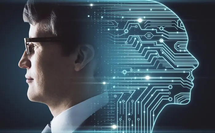 Man in profile beside a glowing circuit-board outline of a head, representing artificial intelligence in digital marketing